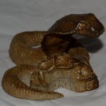 A stoneware salt fired ceramic snake.